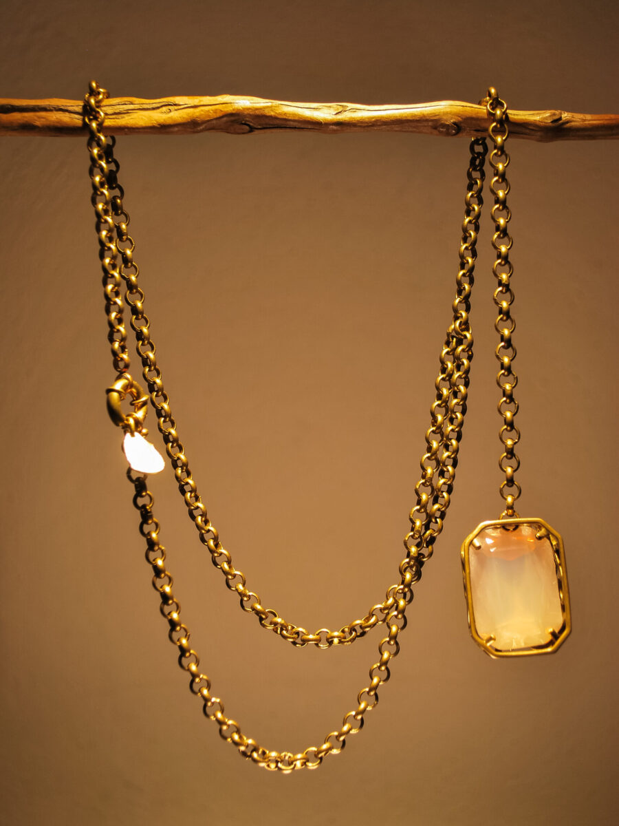 Long brass choker with very light pink rectangular crystal